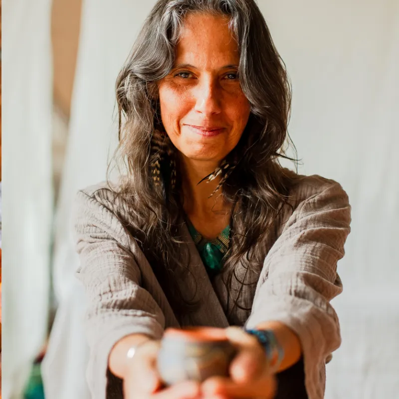 Camille Barrios offering a cup of cacao to the viewer
