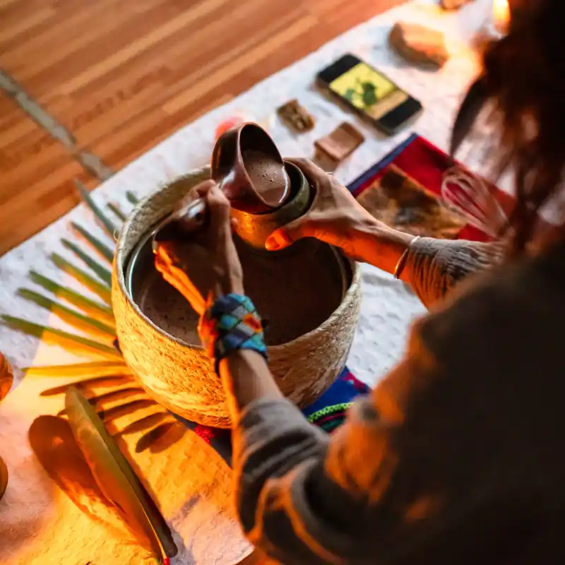 Camille Barrios pouring a cup of cacao