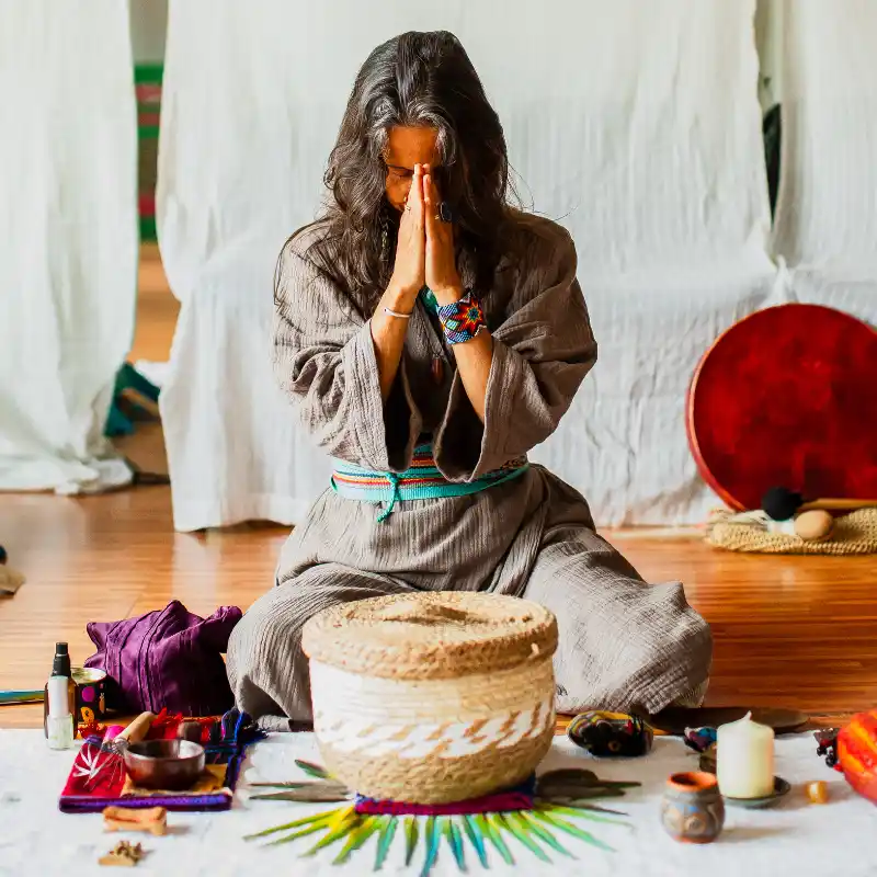 Camille Barrios praying with eyes closed over ceremonial cacao