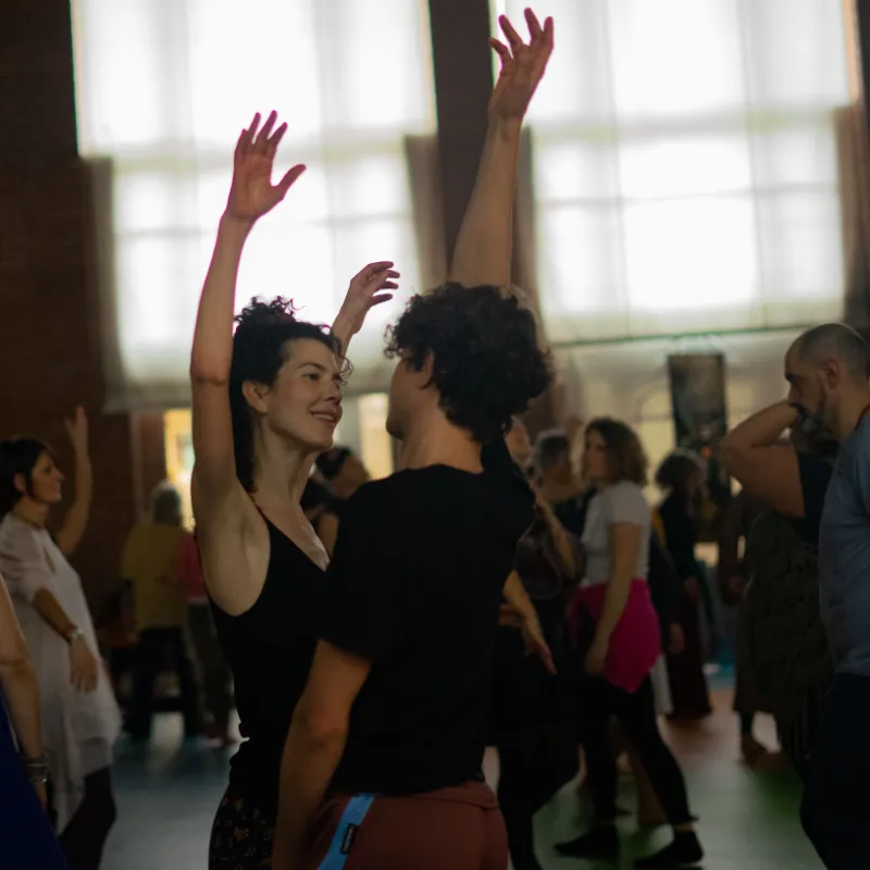 Group of dancers moving together during a movement medicine class